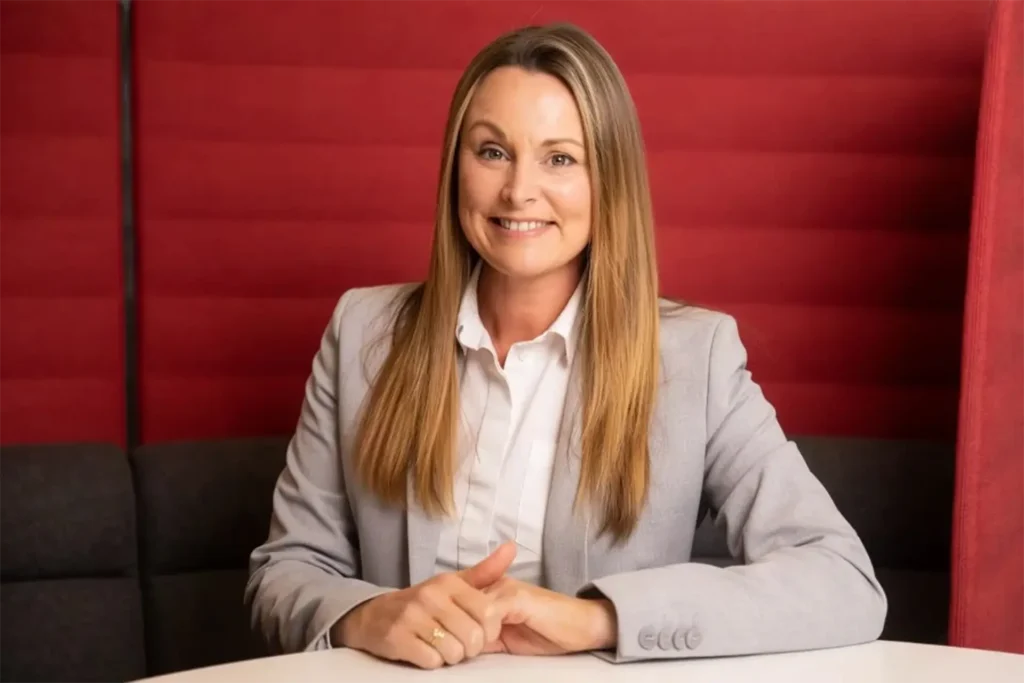 A photograph of a business woman in an office environment. An example of MADE BY WOODSMOKE's commercial headshot photography.