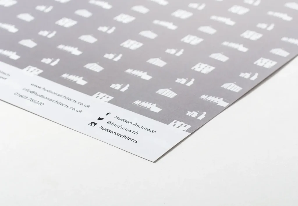 Close up photograph of the grey and white logo pattern on the back of the brochure.