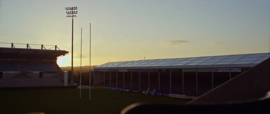 Nuffield Farming 2023 banner showing sunrise over Exeter Chiefs’ stadium, warm light across empty stands and pitch