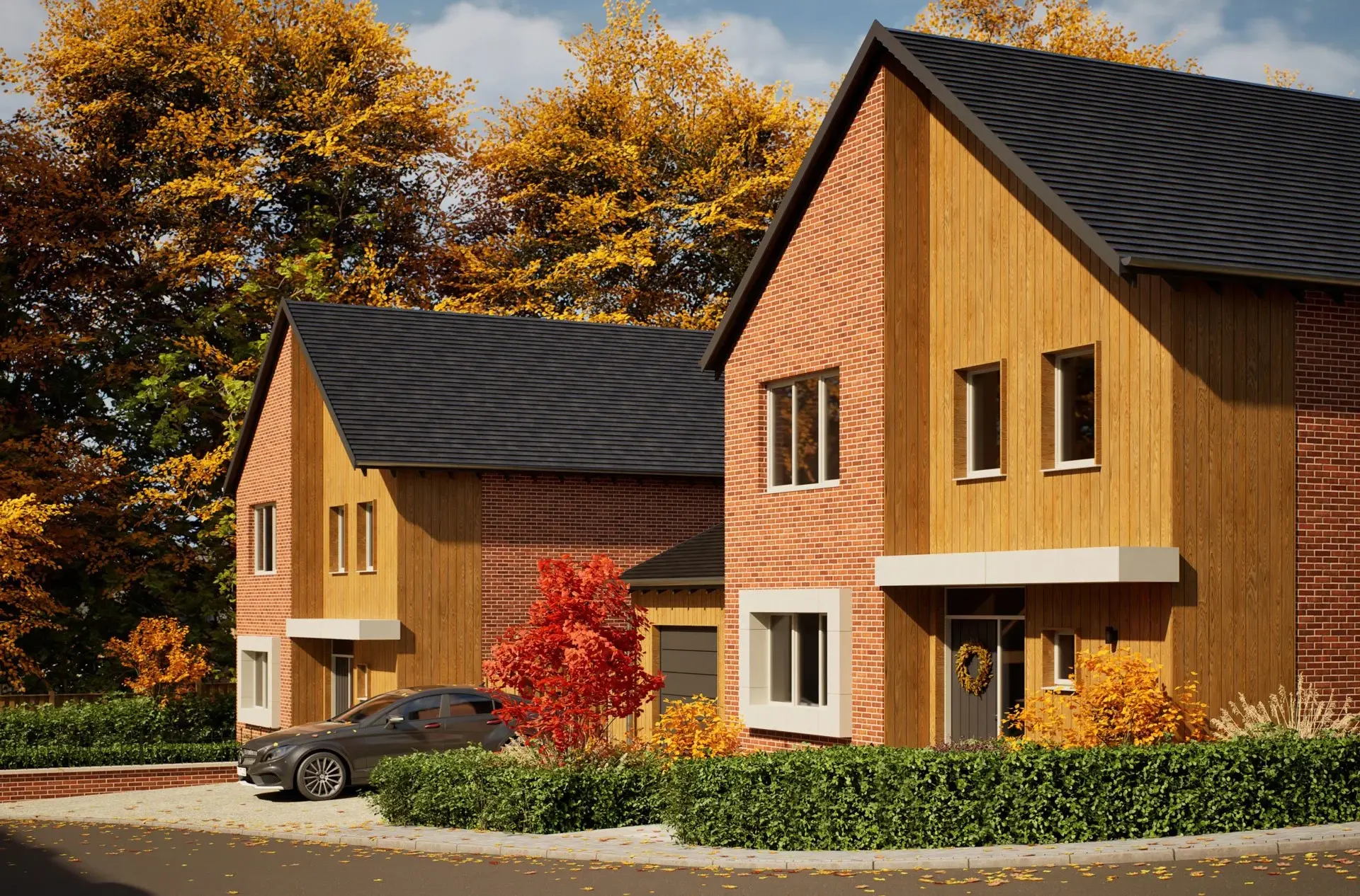 A computer generated seasonal image of two houses at The Lodge, Drayton. Featuring autumn leaves and a warm sun, the image illustrates what it could feel like to live there during the autumn months.  