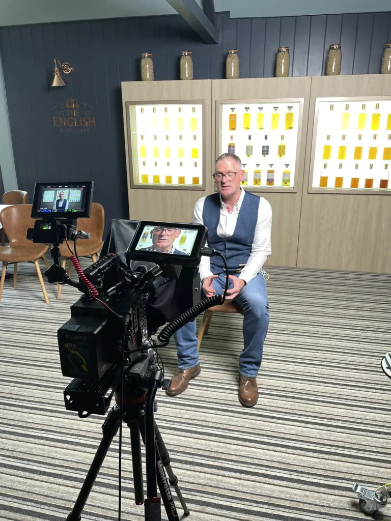 Behind the scenes photograph of a camera being used to create social media content.