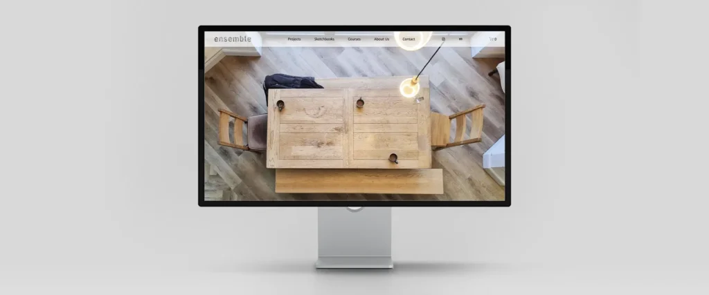 Mockup of a completed website on an Apple Display screen. Project featured is the ENSEMBLE website, a website for a group of Norfolk-based architects, technologists and creatives.