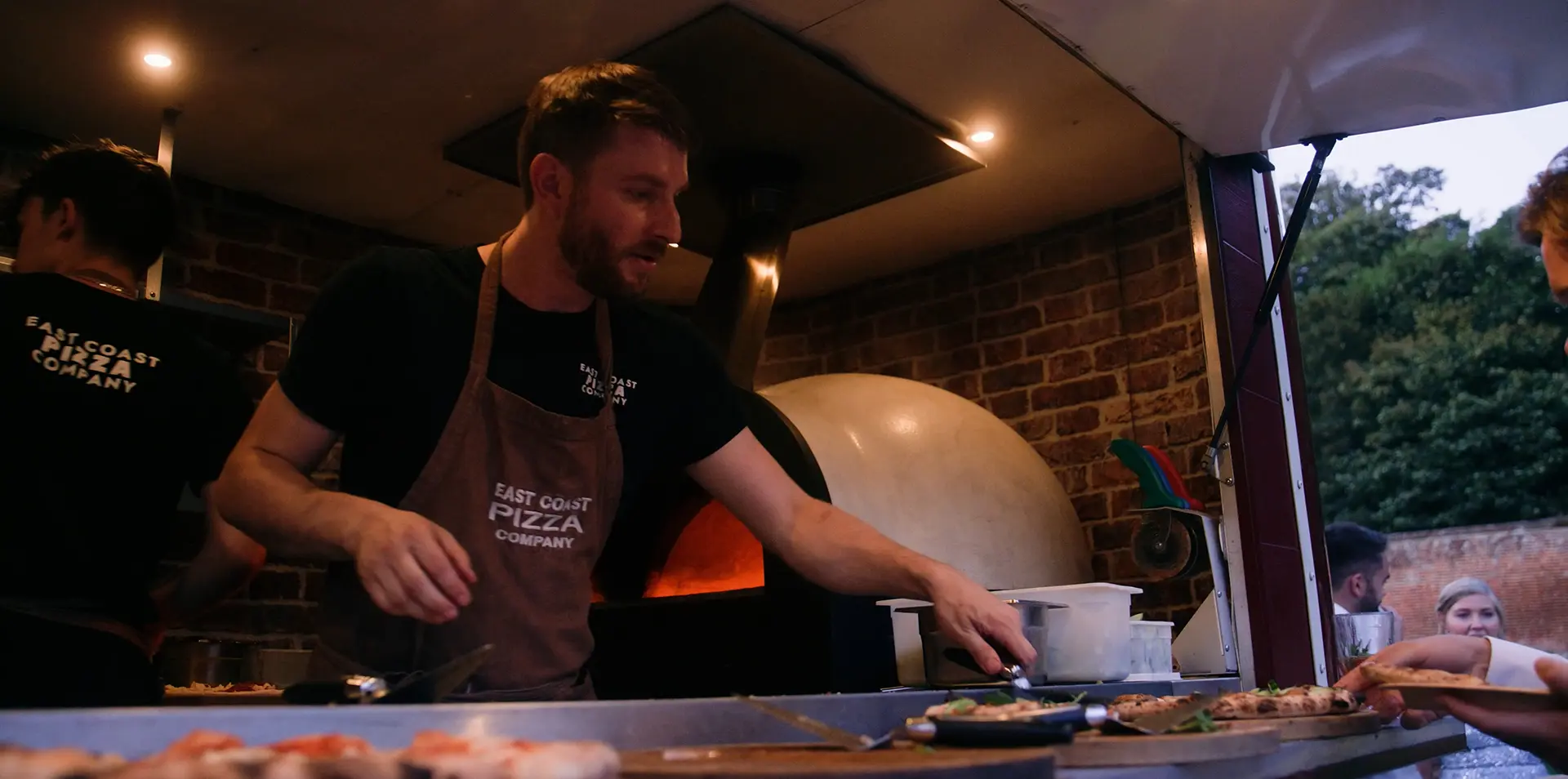 Frame from an events video featuring the East Coast Pizza Company making pizzas