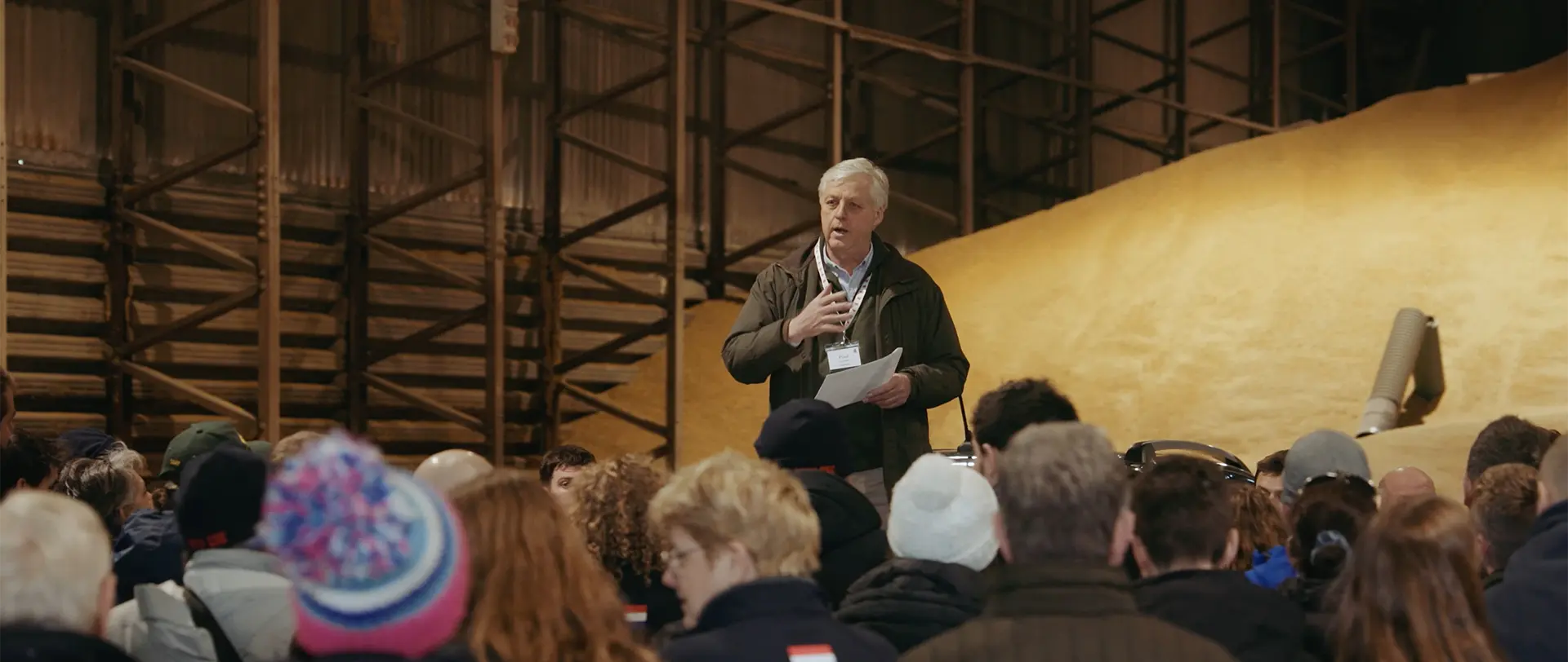 Still image of a man presenting at a farming conference