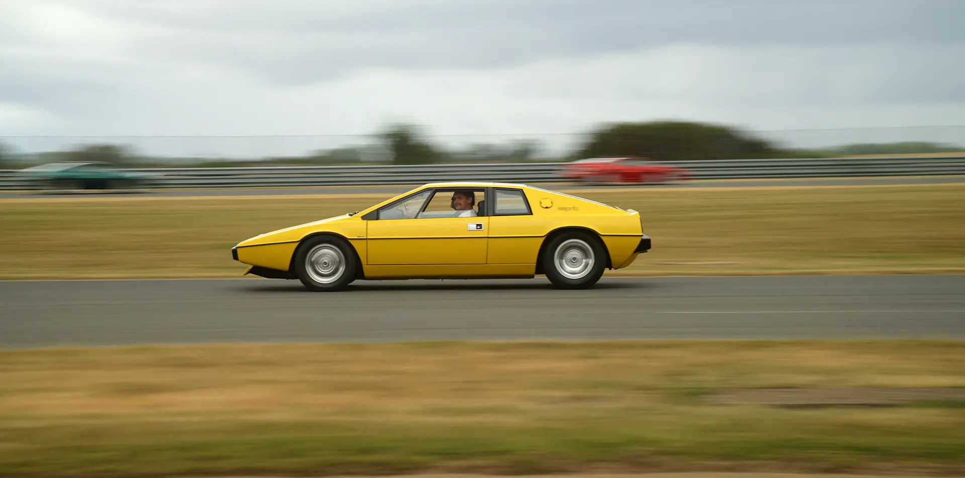 Still frame of the Lotus Cars events film, capturing a Lotus Esprit driving around the track